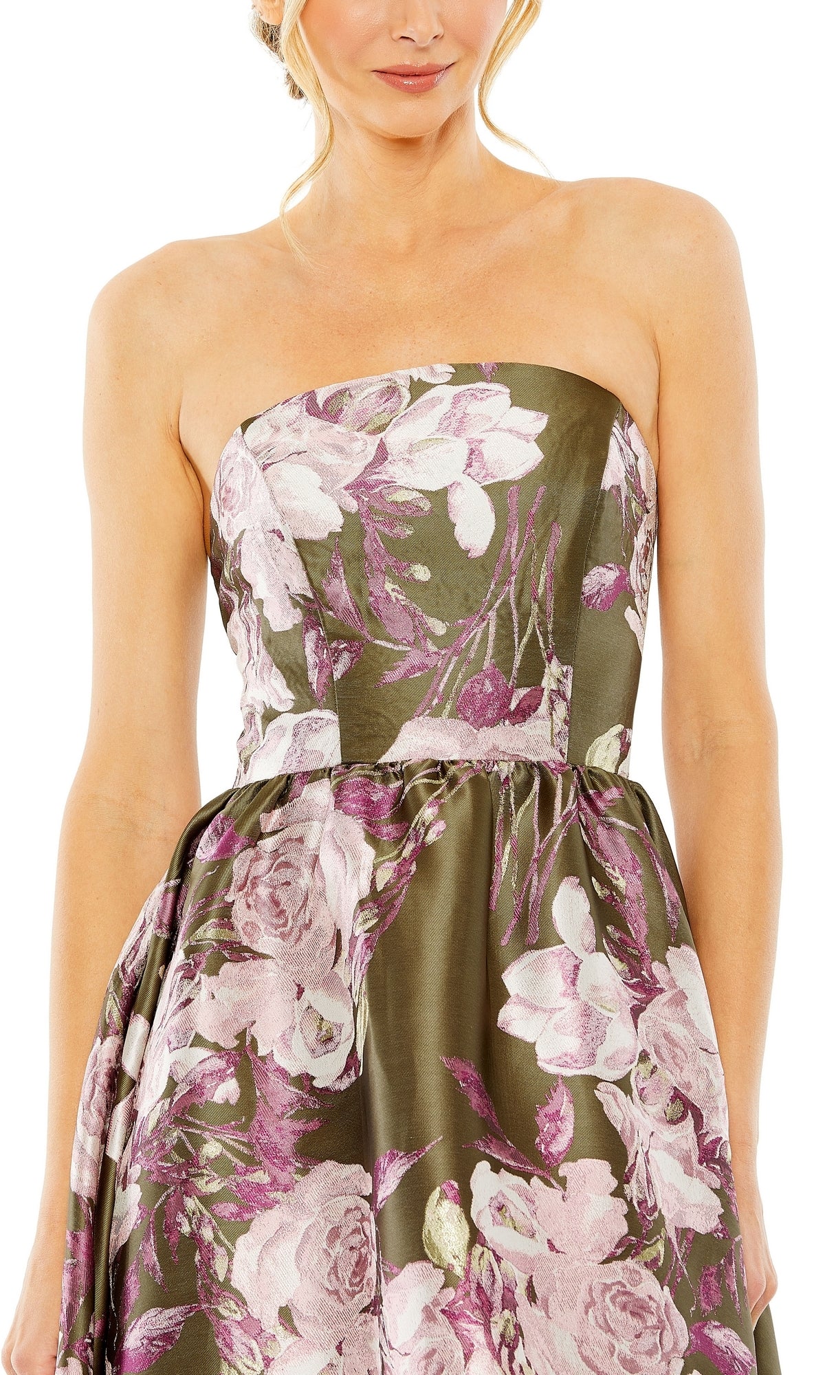 A woman wears the Mac Duggal 11605 Green Floral-Print Formal Dress, a strapless olive design with pink flowers, shown from shoulders to mid-thigh against a white background. An elegant choice for formal occasions.